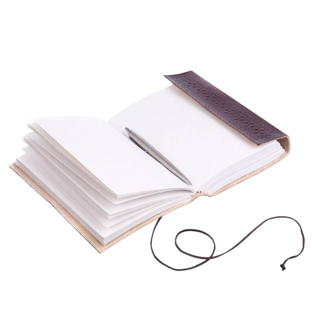 Three Moons Leather Journal open on a surface with unlined handmade khadda paper visible and a pen resting inside, ready for writing.