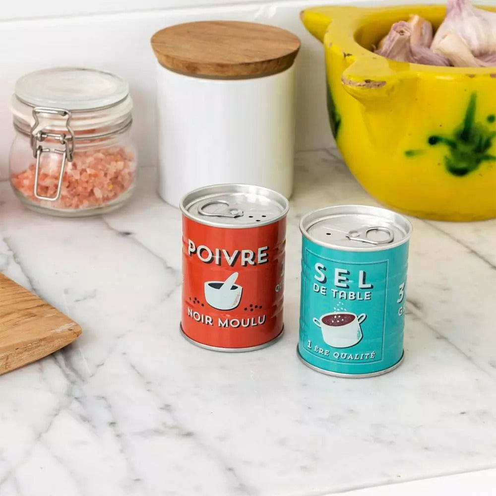 Retro French metal salt and pepper shakers with Sel & Poivre branding on a marble background