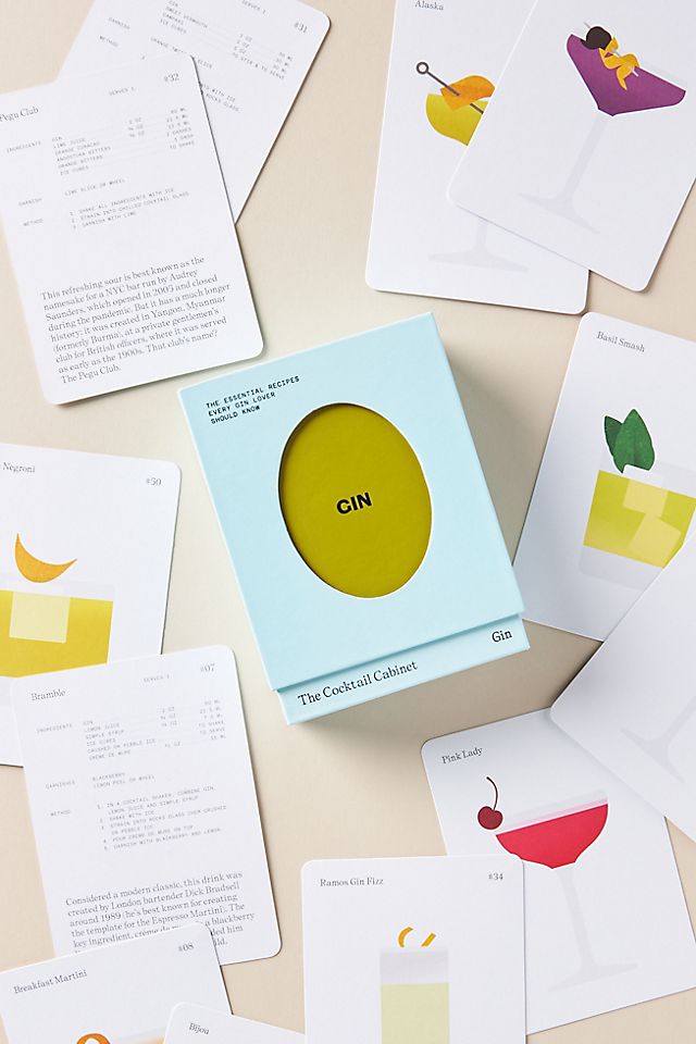 The Cocktail Cabinet: Gin recipe deck centered on a grey surface with cocktail cards spread around