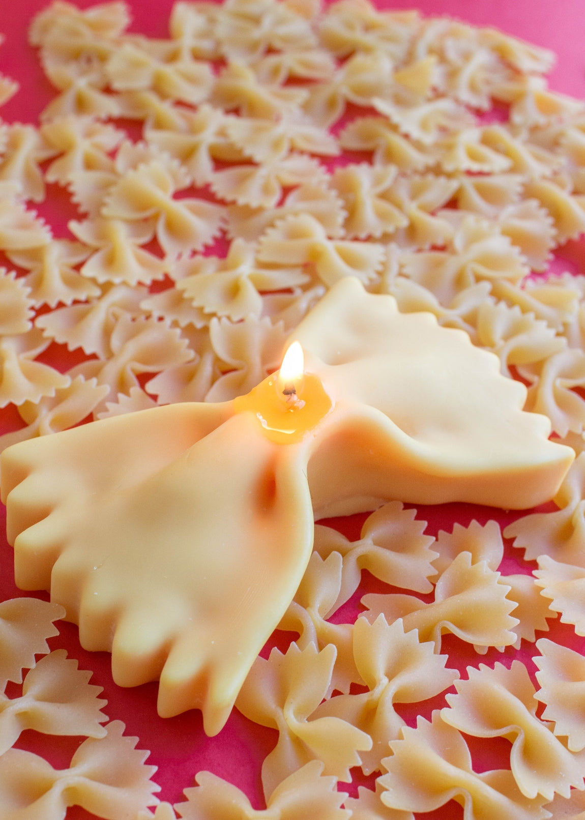 Bow tie pasta on a pink background