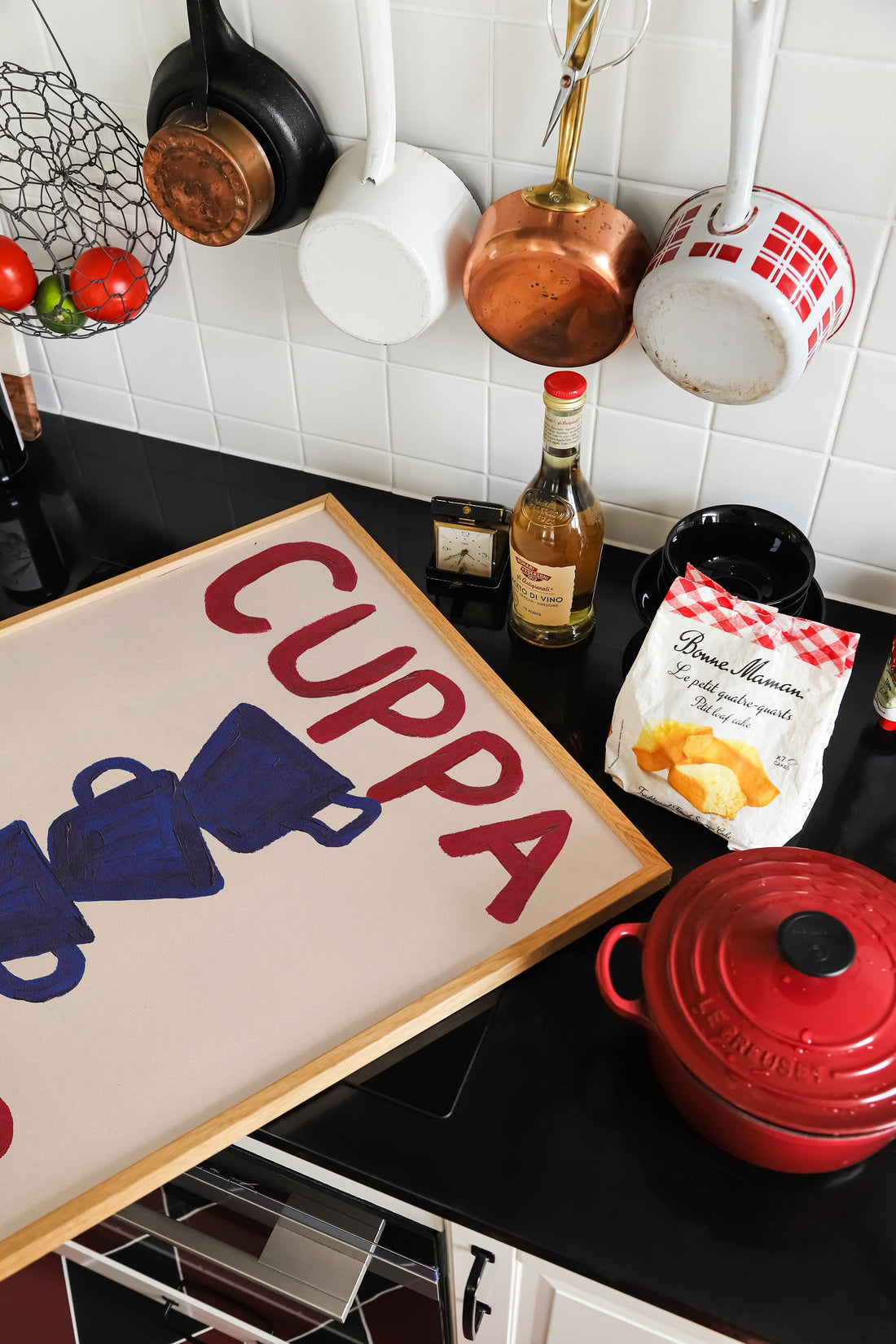 Kitchen counter with Cuppa Tea framed A3 art print, red teapot, and assorted kitchen décor items