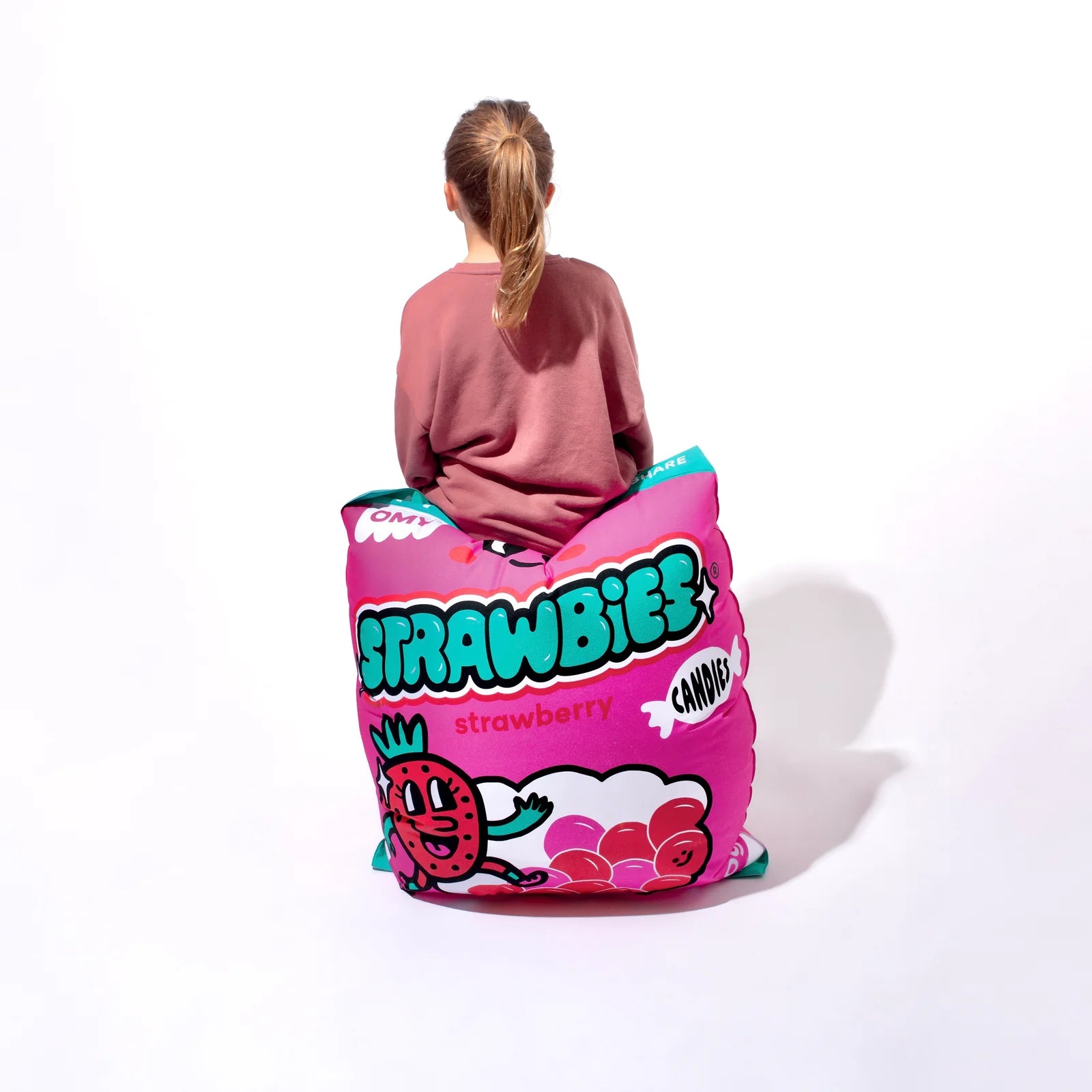 kid sitting on a giant strawberry Inflatable Pillow