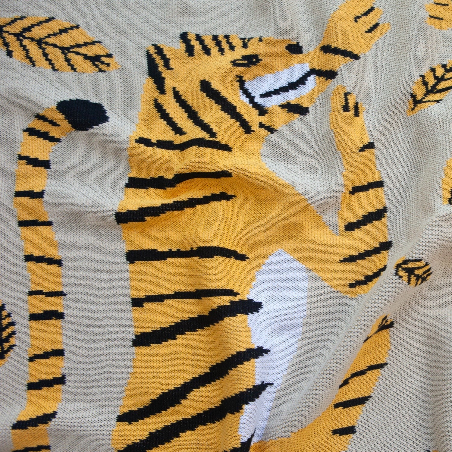 Close Up of the Big Cats Mini Blanket 30x40 inches, designed by James Daw, featuring two big cats and leaves, made from 50% cotton and 50% recycled polyester, soft and eco-friendly, made in USA
