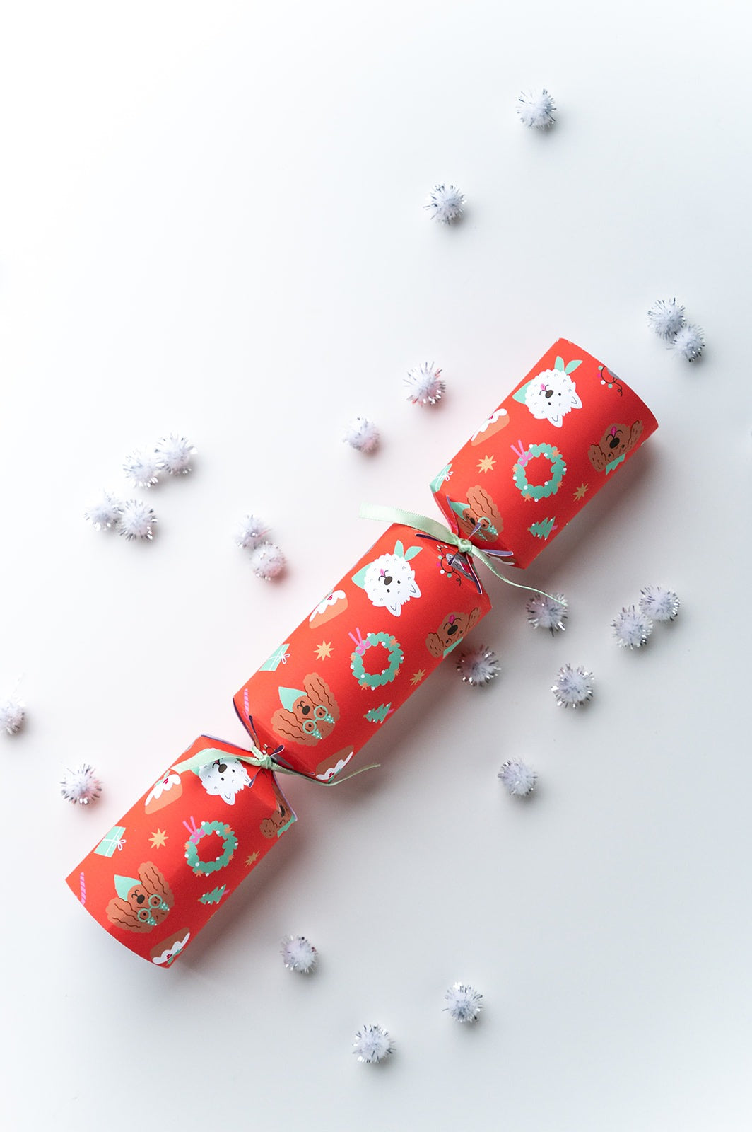 Red Christmas Dog crackers with festive designs on a white background.