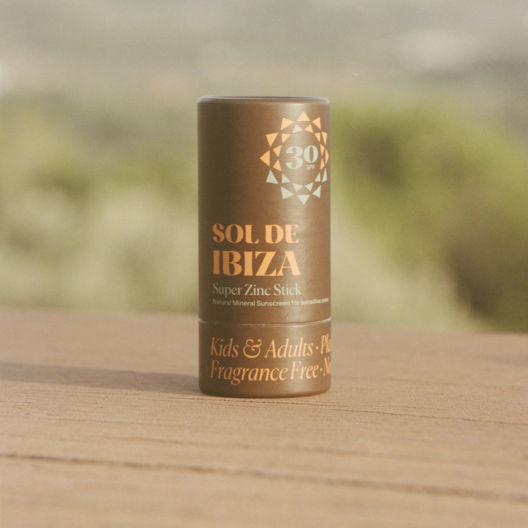 Sol de Ibiza super zinc stick on a wooden surface with a blurred natural background