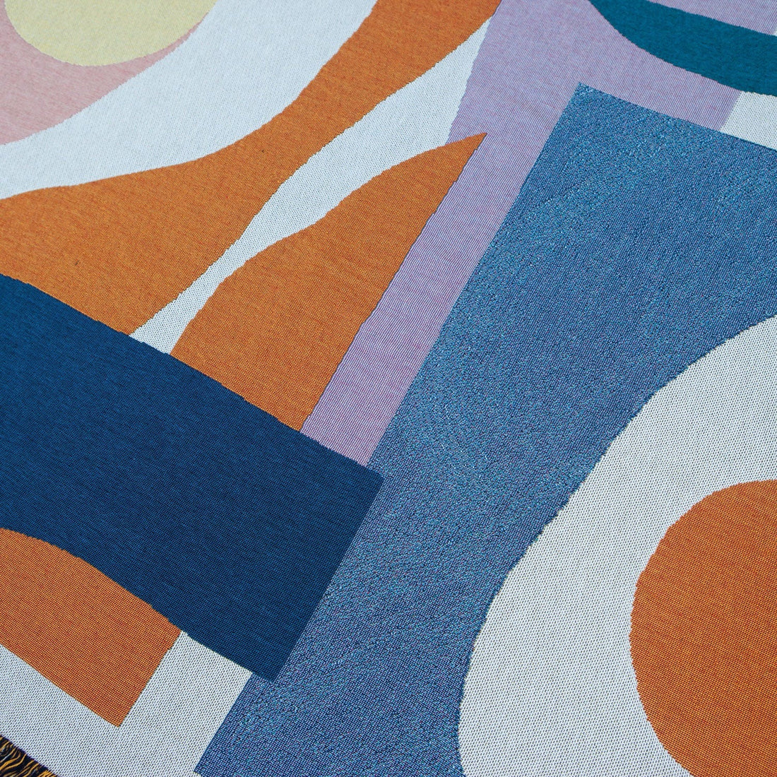 Close-up of the Essien Throw 54x70 inches, designed by Noémie Cédille, woven from 100% cotton (25% recycled), eco-friendly, versatile for couch, bed, picnic, or wall décor, made in USA