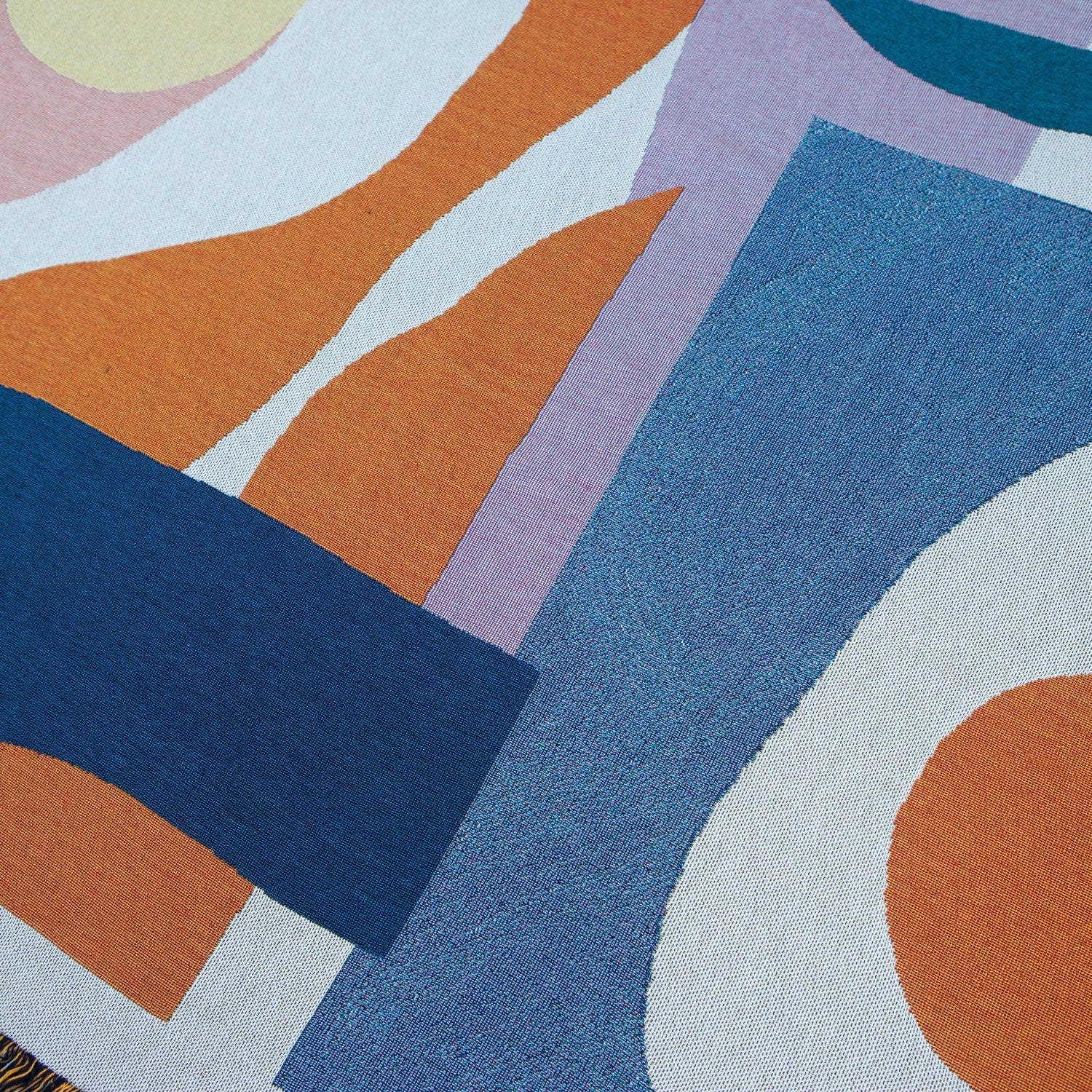Close-up of the Essien Throw 54x70 inches, designed by Noémie Cédille, woven from 100% cotton (25% recycled), eco-friendly, versatile for couch, bed, picnic, or wall décor, made in USA