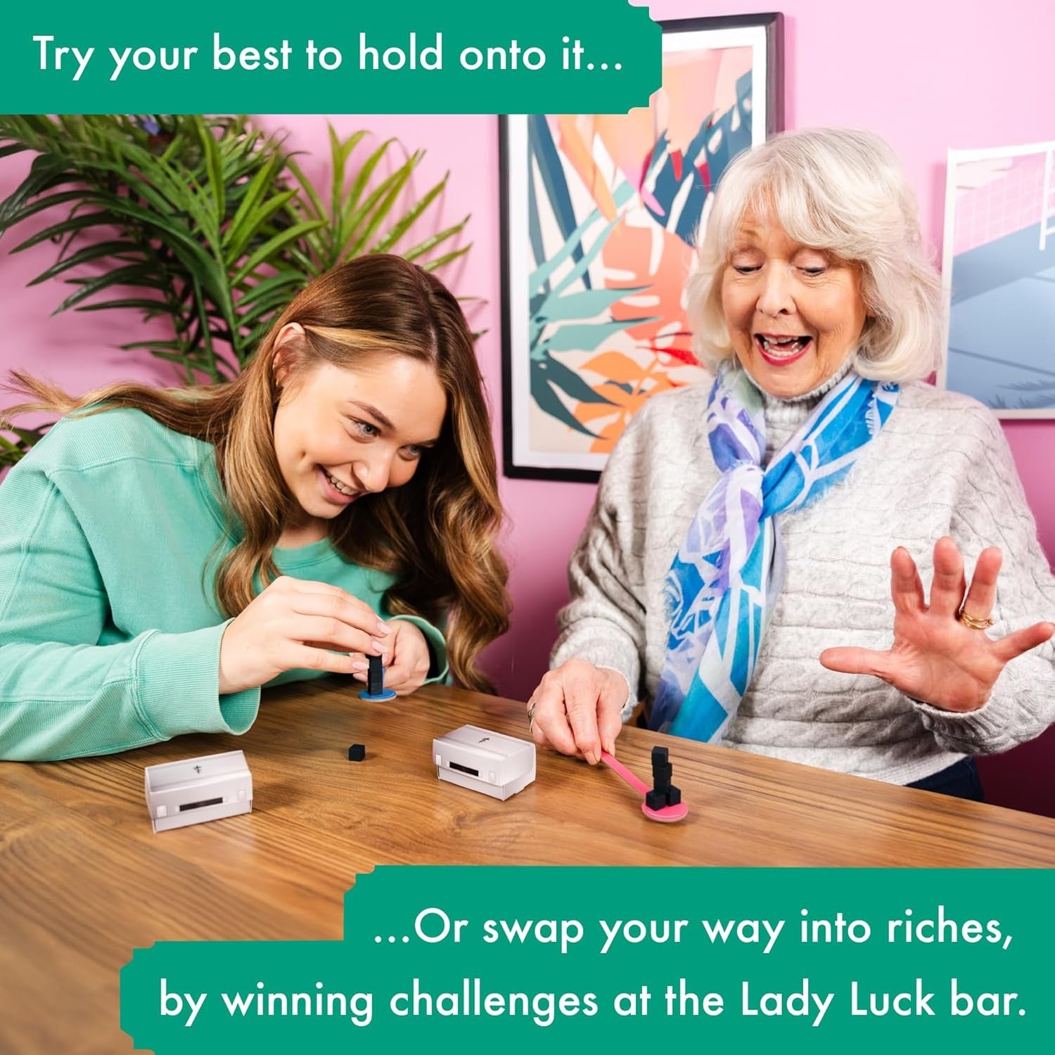 Two players of different ages enjoying the Fortune Hotel board game, competing in mini-challenges and swapping briefcases.