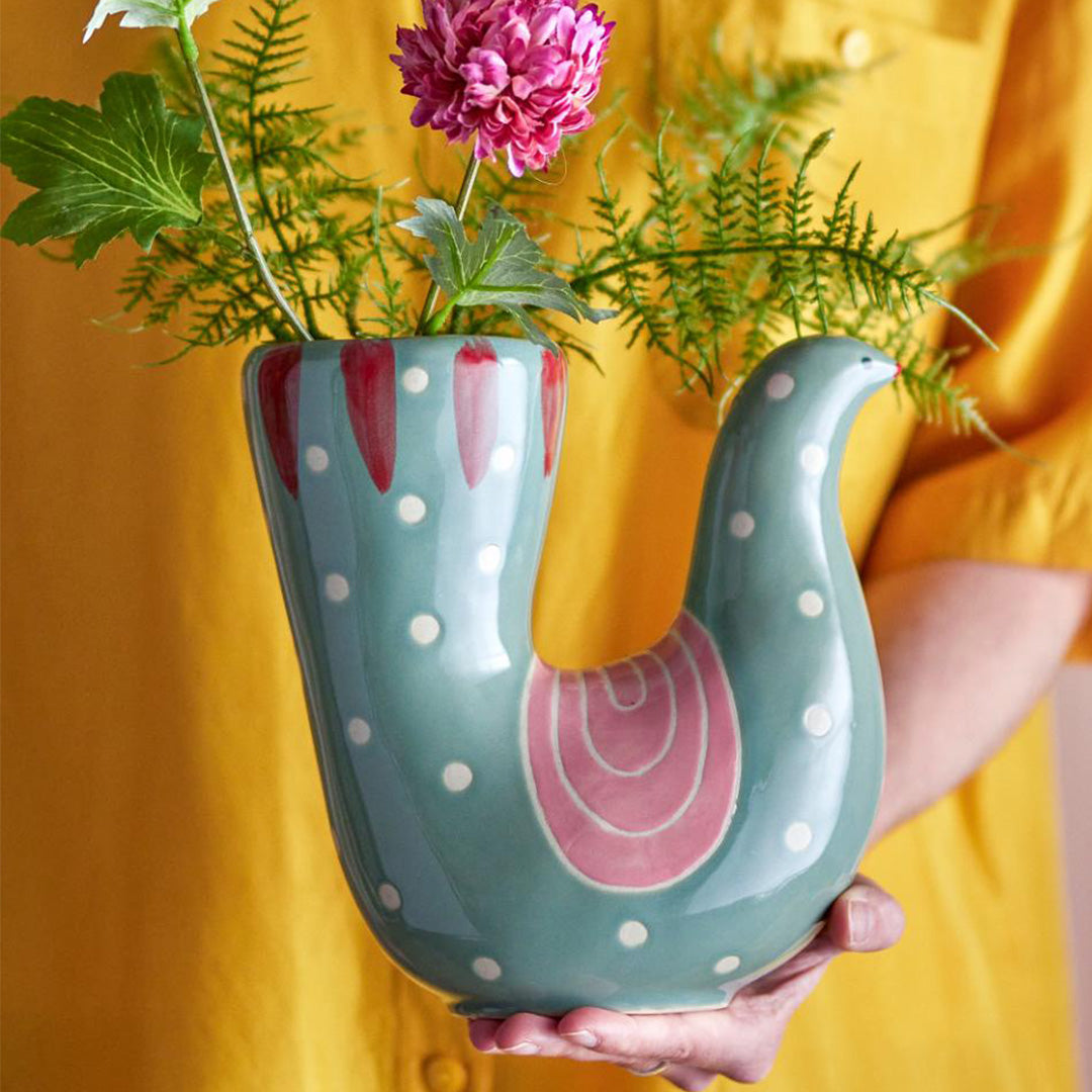 A person holding in their hand the Trudy Green hand-painted bird-shaped vase