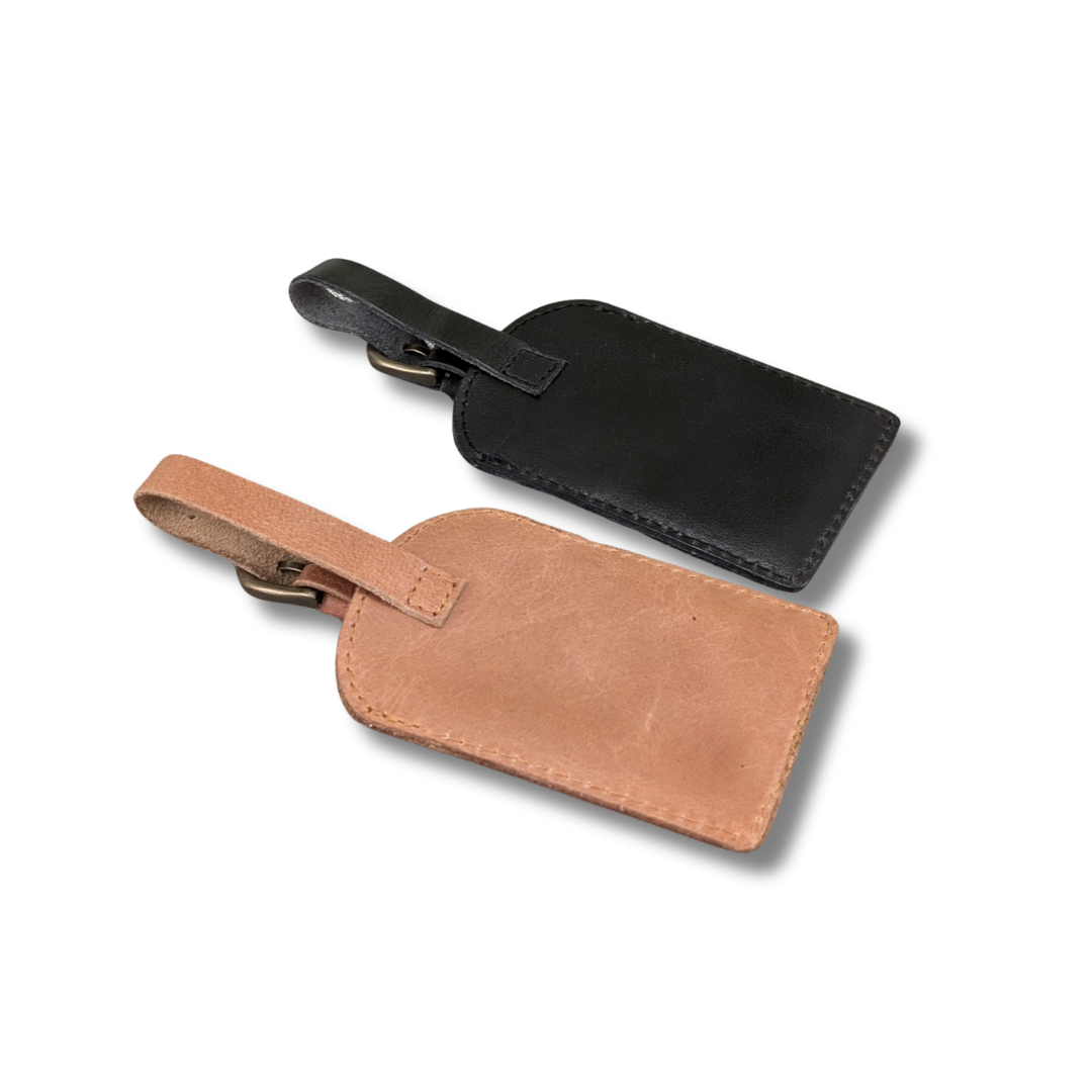 Black and brown leather luggage tags on a white background
