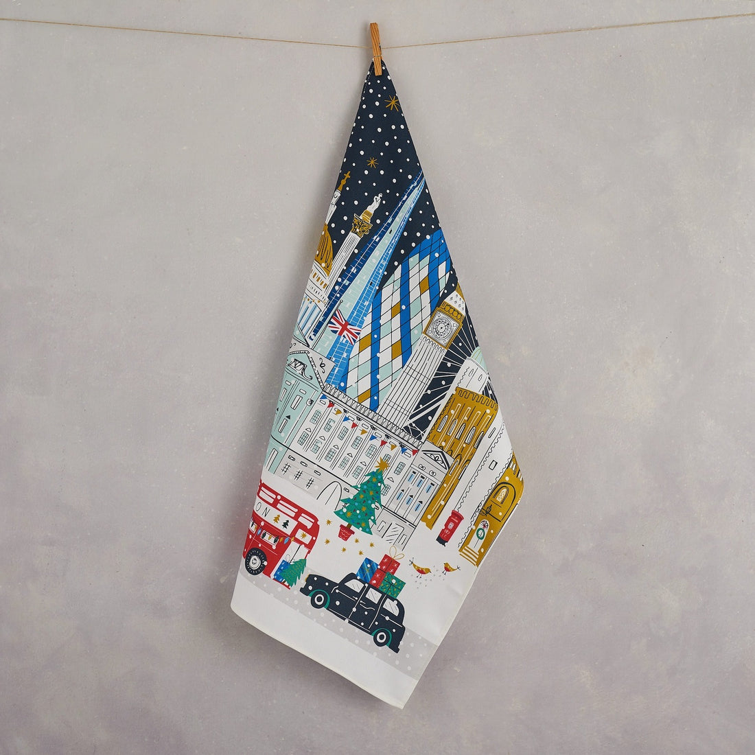 Hanging the Illustrated London tea towel featuring landmarks like the Gherkin and London Eye, 100% cotton, British-made, gift-ready packaging