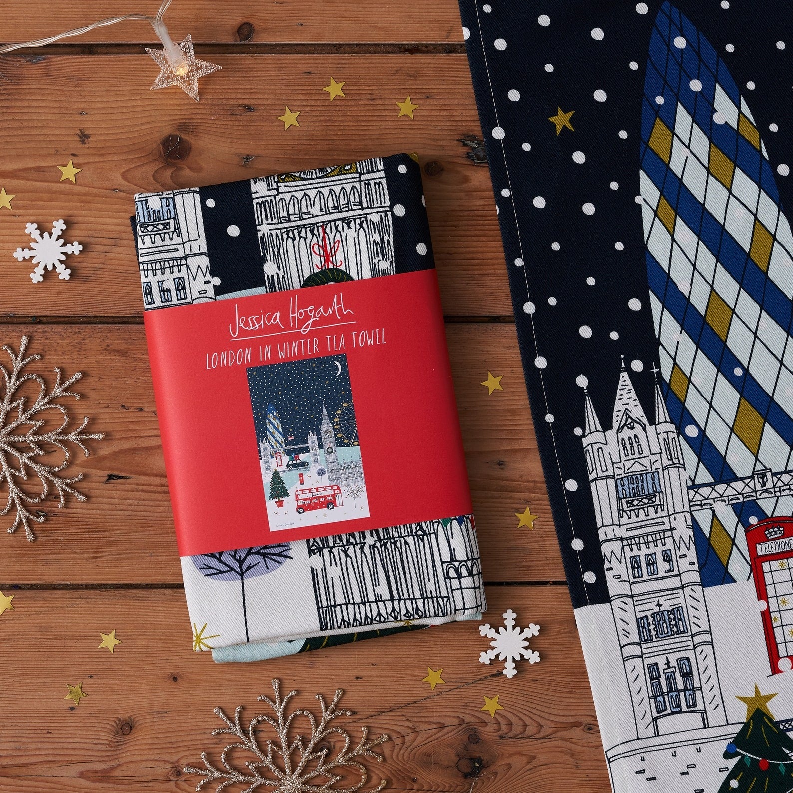 Packaged London Winter Thames Tea Toweln a wooden surface with decorative elements.
