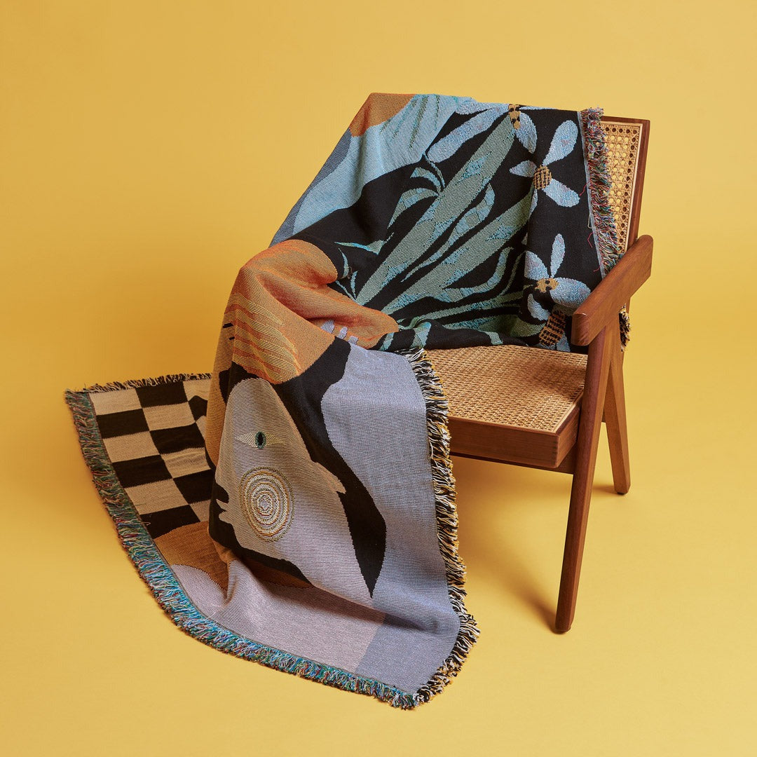 Moretti Throw with a wicker chair and yellow background