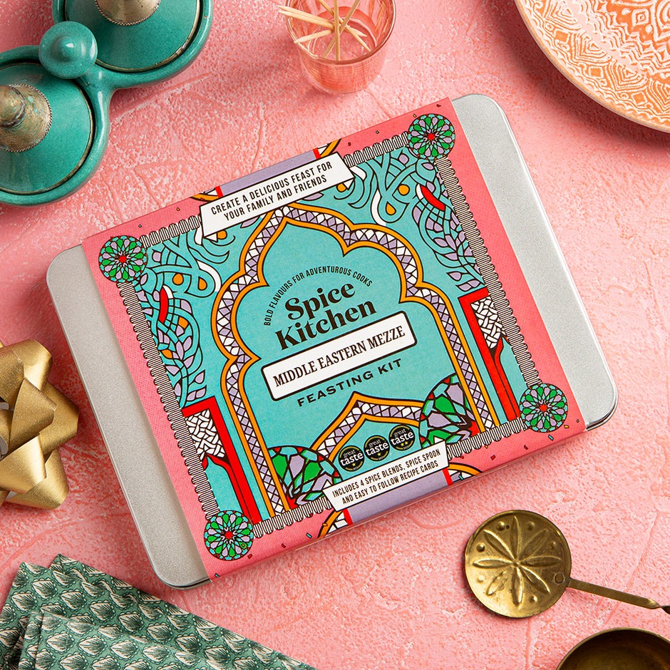 Spice Kitchen Middle Eastern Mezze Feasting Kit on a pink surface with decorative items.