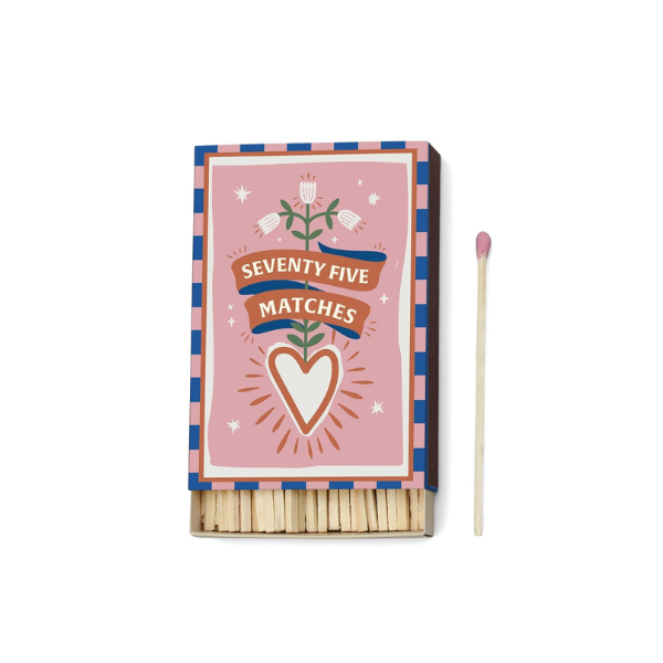 Decorative matchbox with floral heart design, labeled seventy-five matches, with pink-tipped matchstick