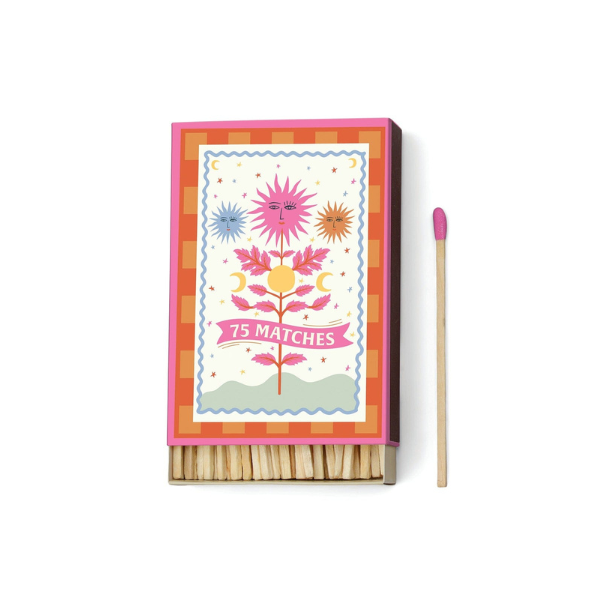 Decorative matchbox with mystical floral sun design, labeled seventy-five matches, with pink-tipped matchstick