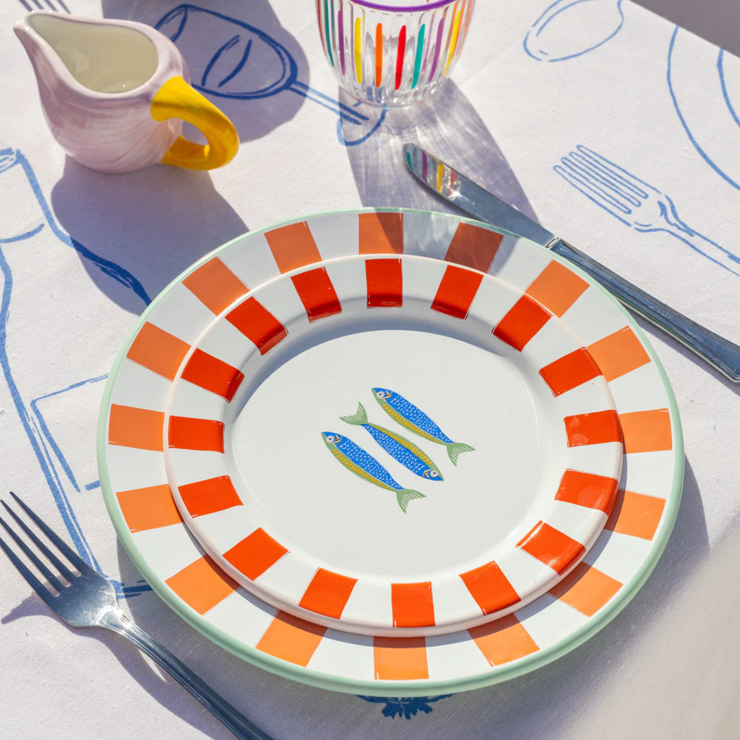 Enamel plate with red stripes, pink trim, and three illustrated sardines in the center.