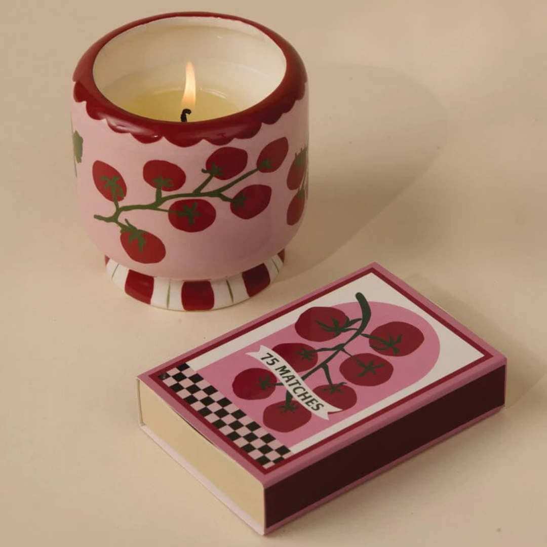 Vegan soy wax candle in ceramic tomato jar with red-tipped matches and decorative matchbox labeled seventy-five matches