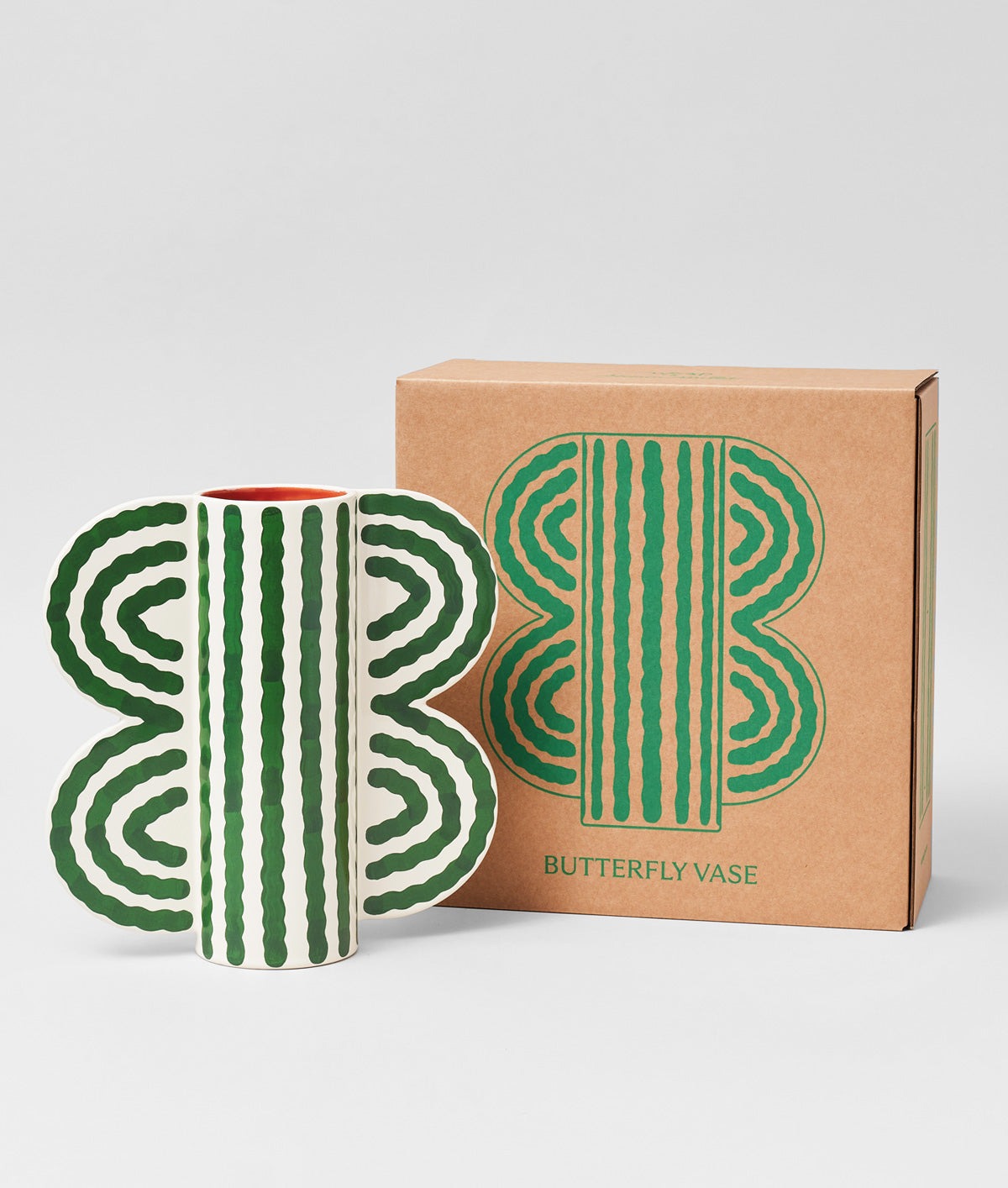 Butterfly Vase by Séverin Millet displayed next to its packaging, off-white ceramic with green wave pattern, on a white background.
