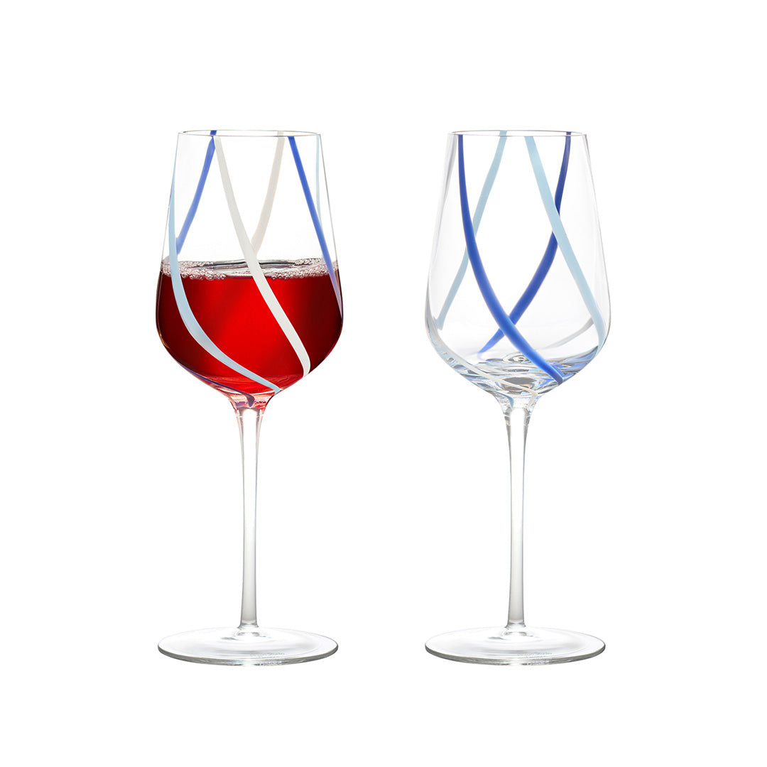 Handcrafted swirl wine glasses filled with red wine on a white background, featuring vibrant blue and azure colors with long stems