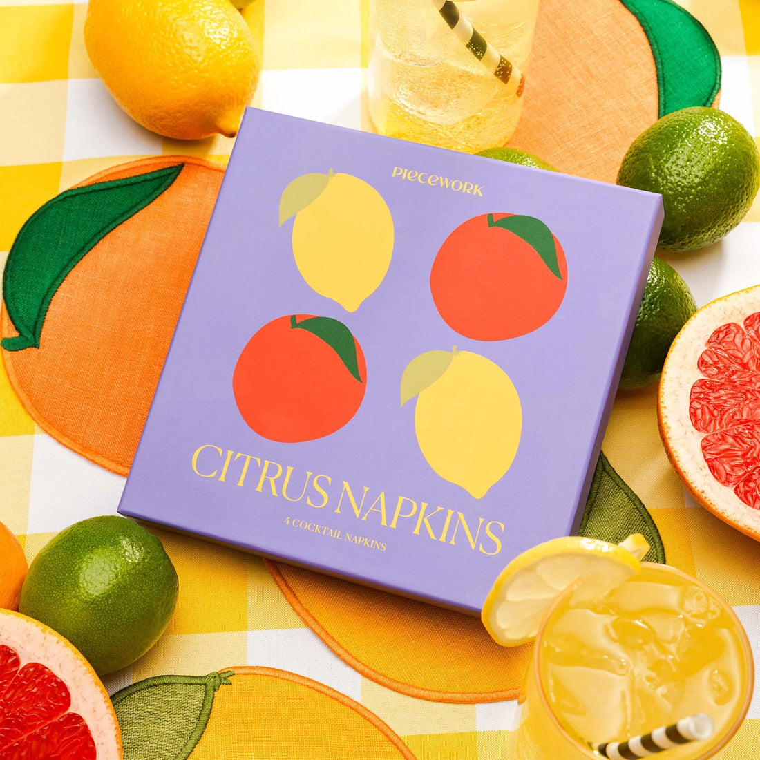 Set of four citrus-shaped linen cocktail napkins in a playful and sustainable box with citrus illustrations.