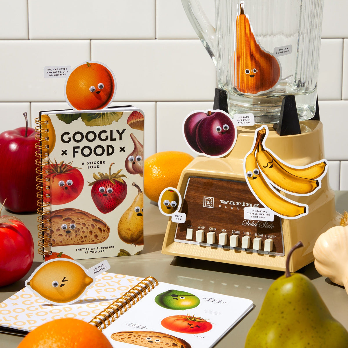 Blender with animated fruits and a book titled &