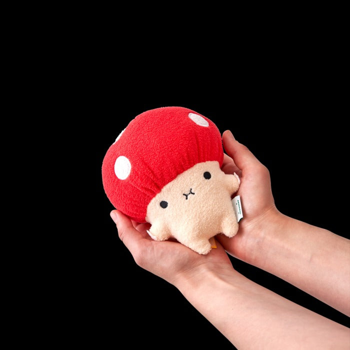 Two hands holding the mushroom plush soft toy