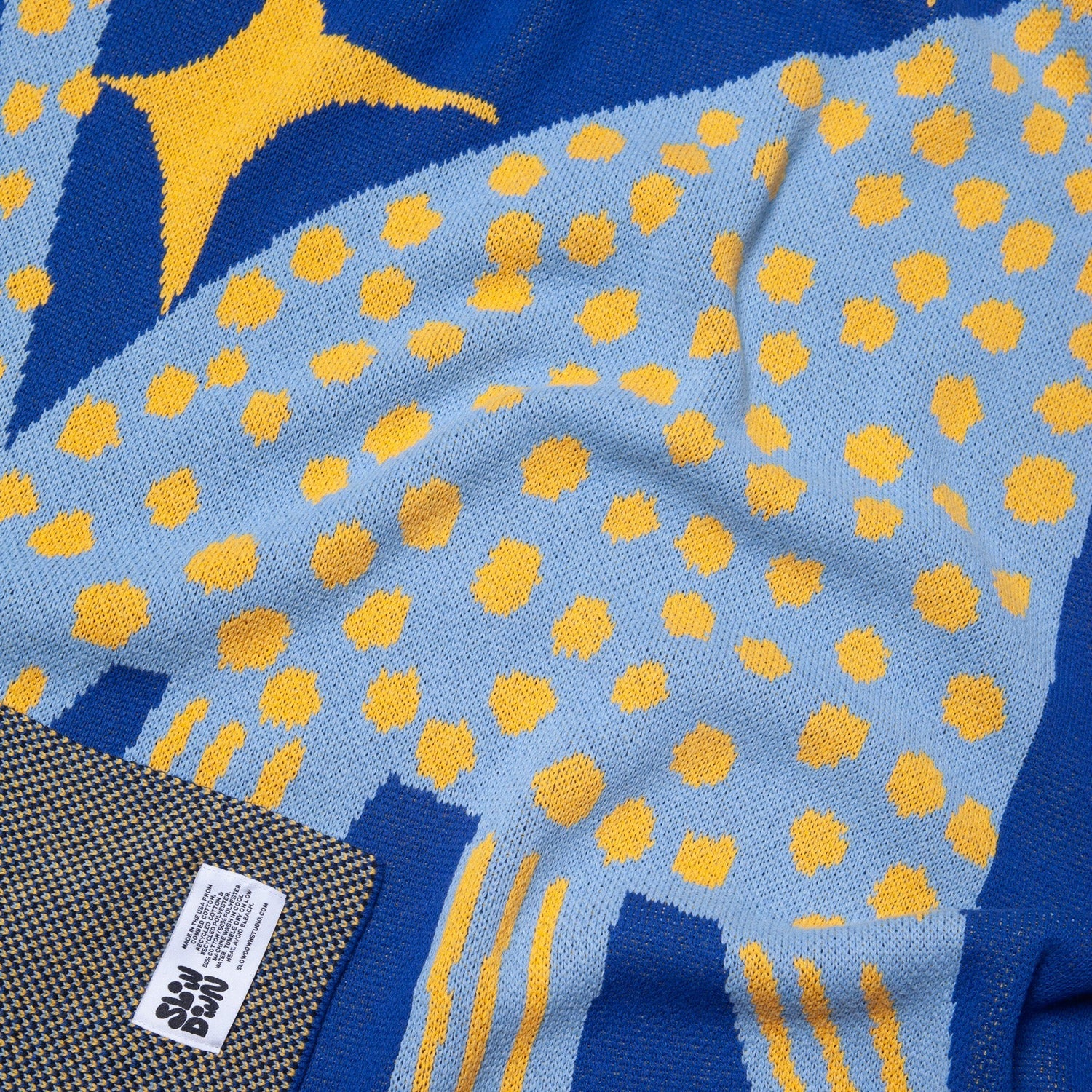 Close up of the Starry Night Mini Blanket 30x40 inches, designed by Marcello Velho, made from 50% cotton and 50% recycled polyester, soft, durable, eco-friendly, made in USA, perfect for babies