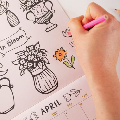 Close- upfo the 2026 colouring wall calendar with month-to-view layout and illustrations to colour