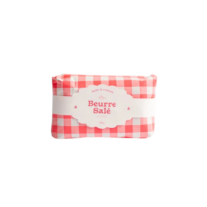 Butter candle with a red and white checkered wrapper on a white background