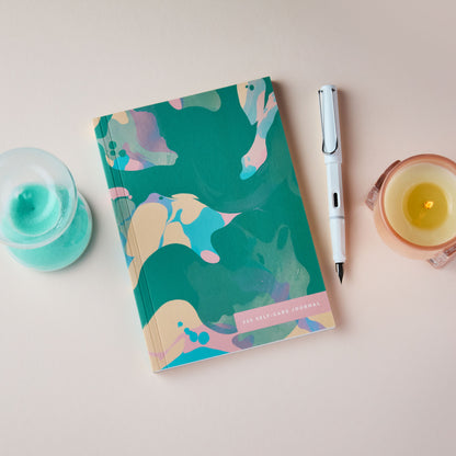 365 Self Care Journal teal marble with a pen, and candle on a light surface