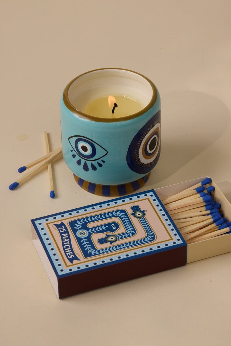 Vegan soy wax candle in ceramic heart jar with blue-tipped matches and decorative matchbox labeled seventy-five matches