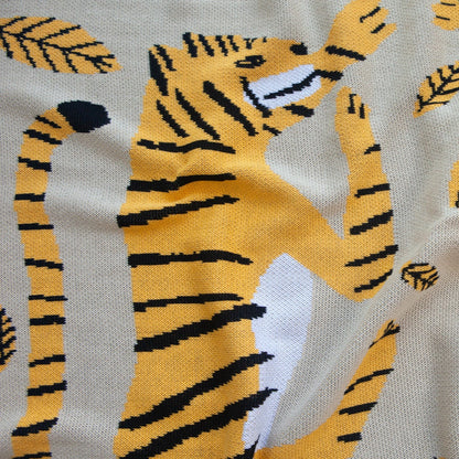 Close Up of the Big Cats Mini Blanket 30x40 inches, designed by James Daw, featuring two big cats and leaves, made from 50% cotton and 50% recycled polyester, soft and eco-friendly, made in USA