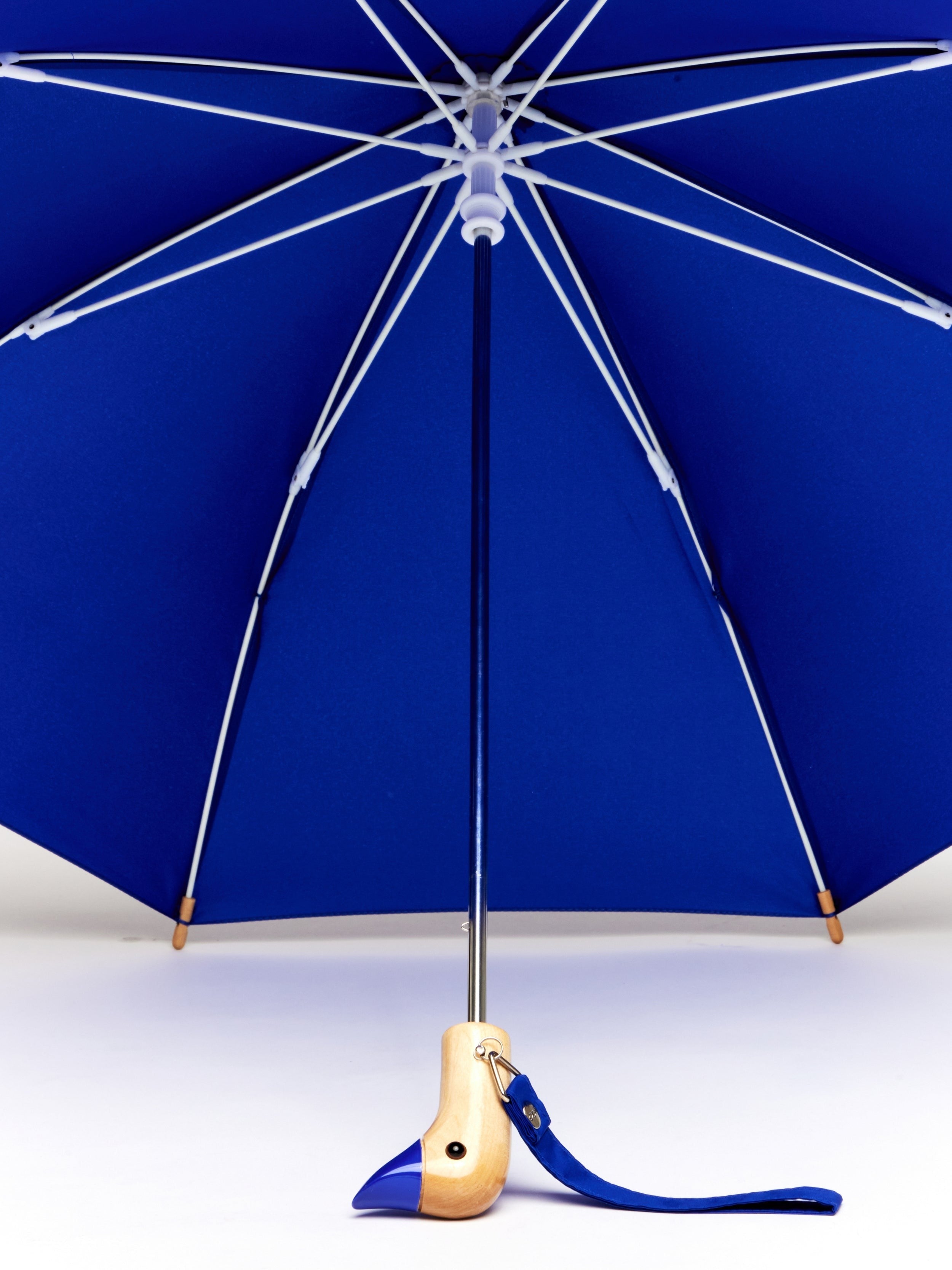 close up of the The Duckling children’s umbrella in  red with recycled plastic canopy and wooden handlelue
