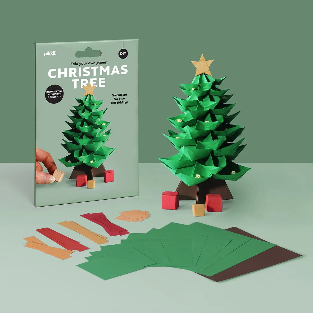Origami Christmas tree kit with packaging and materials on a green background