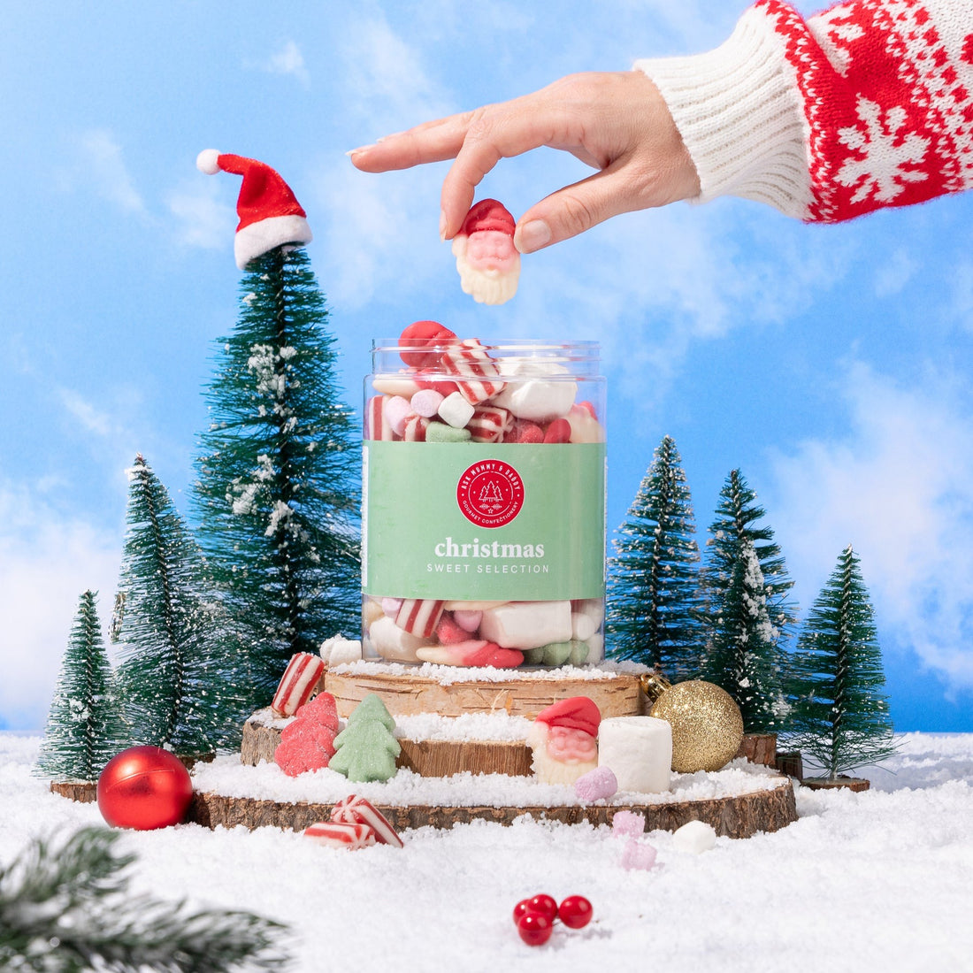 Hand reaching for a candy in a jar labeled &