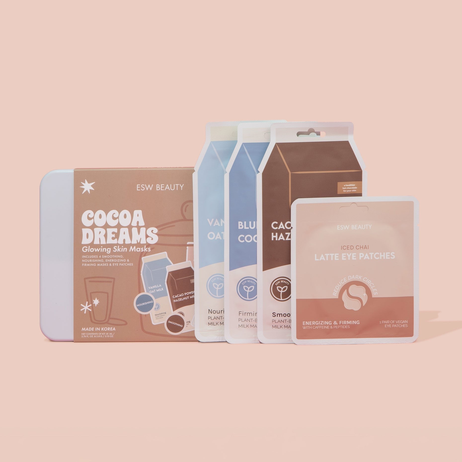 Cocoa Dreams Skincare Treats set including Vanilla Oat Milk Nourishing Mask, Cacao Powder Smoothing Mask, Blueberry Coconut Milk Firming Mask, and Iced Chai Latte Eye Patches in a reusable cookie tin.