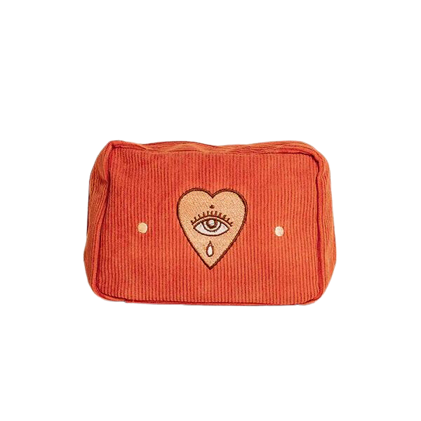 A rectangular makeup bag in orange with a bold sun design embroidered on the front and a double zip fastening.