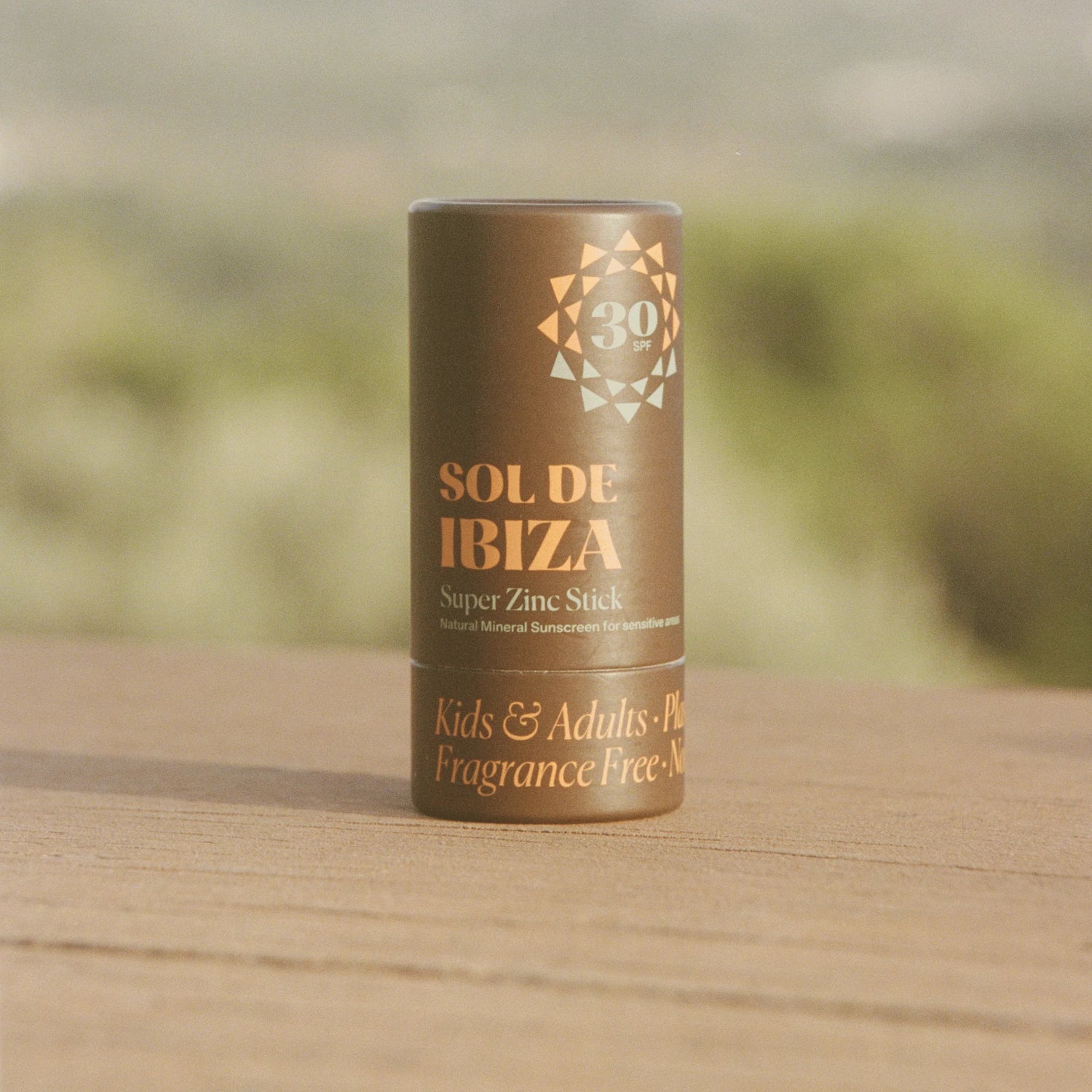 Sol de Ibiza super zinc stick on a wooden surface with a blurred natural background