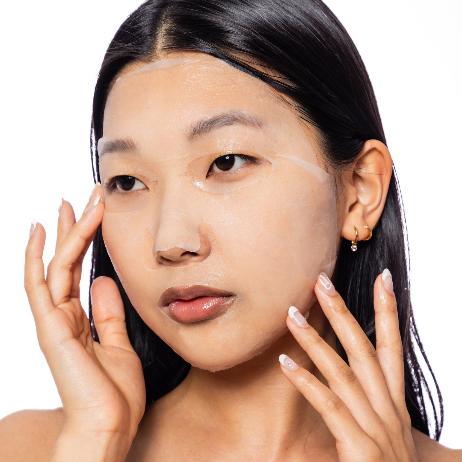 Woman wearing the ESW Beauty  Soothing Mask  on a white background