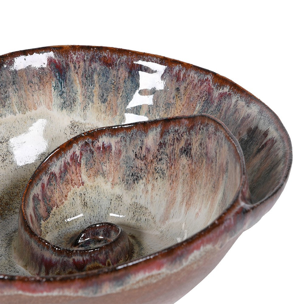 Close-up of a ceramic bowl with a shell-shaped on a white background