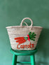 Handwoven palm leaf market basket with embroidered carrot design