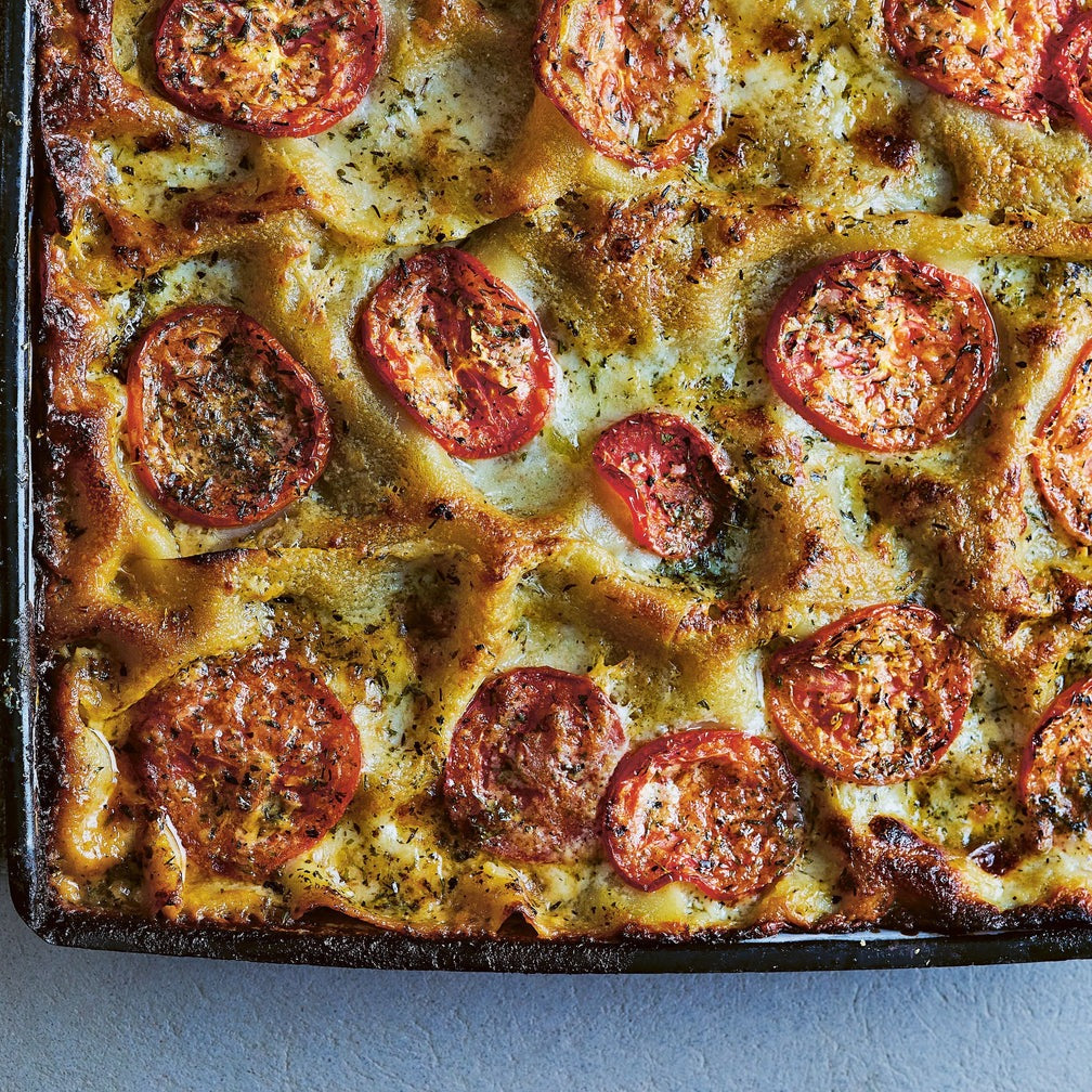 Baked dish with tomato slices with harissa spice on top