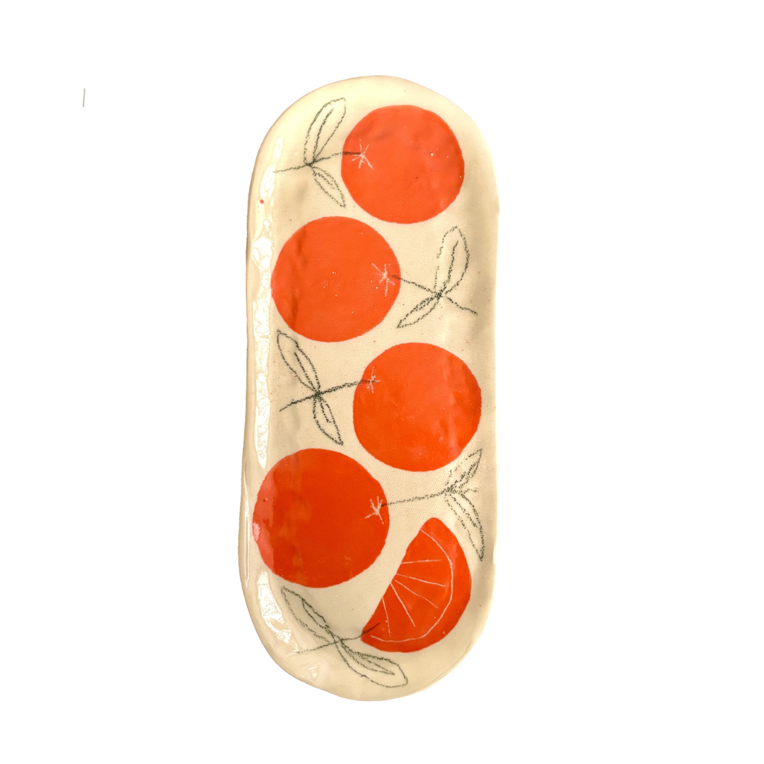 Handmade stoneware serving plate with a hand-painted orange pattern and shallow lipped edge – artisanal ceramic tableware