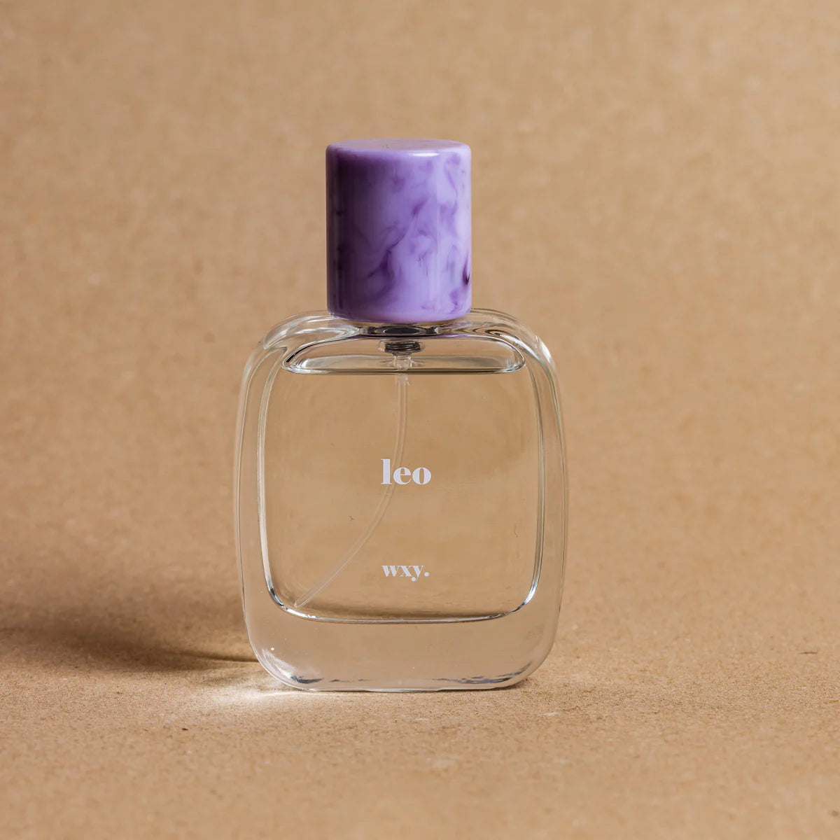 Leo Eau de Parfum bottle on a brown background– bold and opulent fragrance