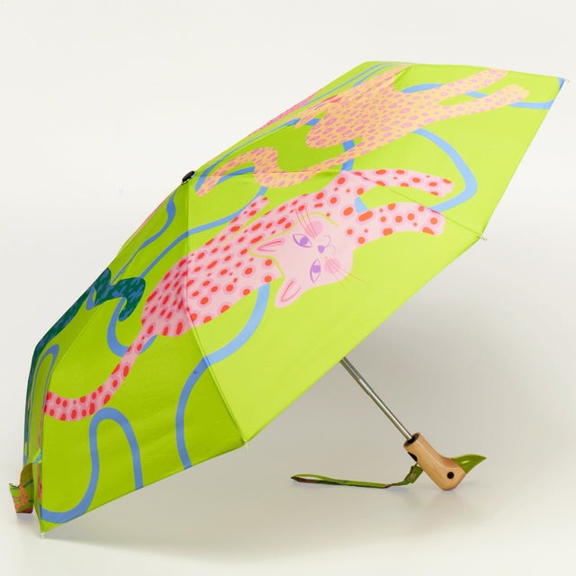 Lime green Arty Cats umbrella displayed open with wooden handle detail