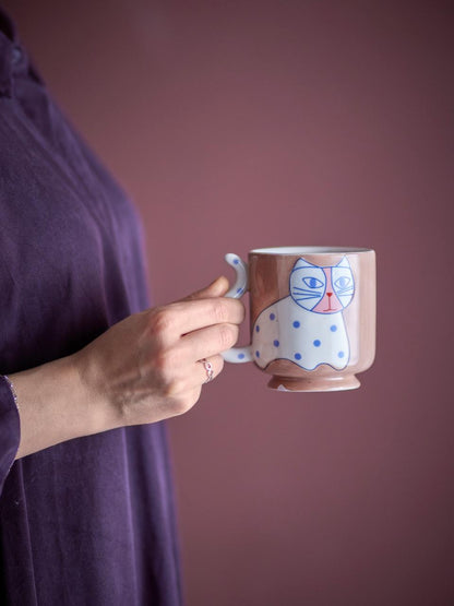 Person holding the Missy mug against a pink background