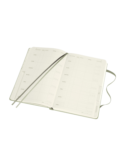 Wellness Journal open, showing two ribbon bookmarks, tabbed sections, and space for tracking habits, goals, and reflections.