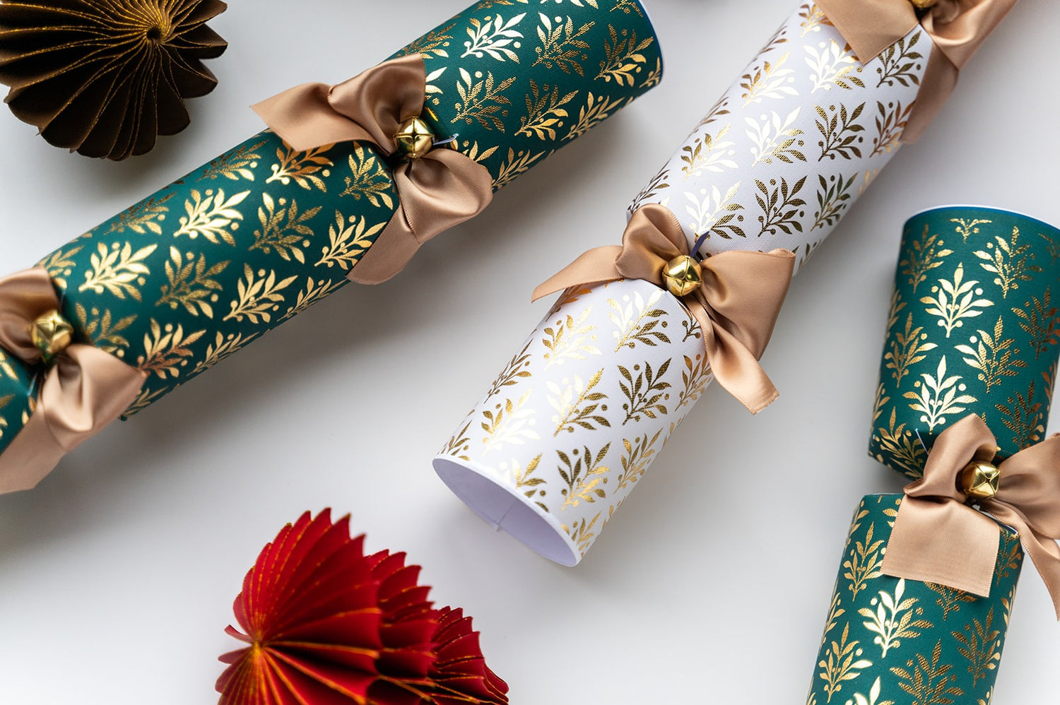 Close-up of the Opulent Christmas Crackers with gold leaf pattern and brown ribbon on a white background
