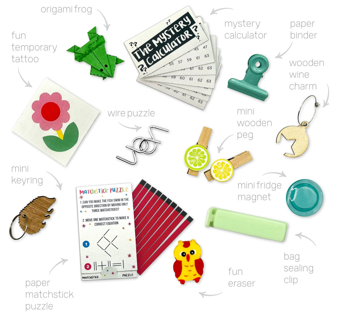 Collection of small items including a paper matchstick puzzle, fun eraser, and various other  gifts that you can found inside the PETIT `C`HRISTMS `CRACKERS SET OF 6